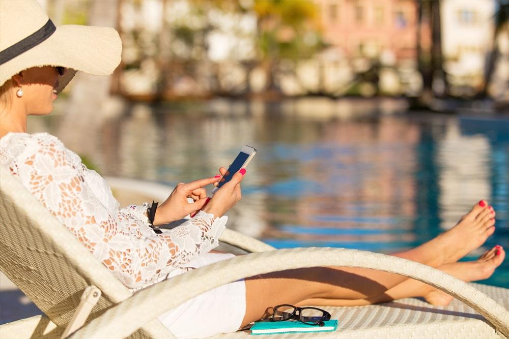 Mom ordering poolside lunch with her smartphone