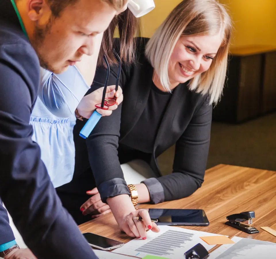 Two accountants, a man and a woman, discussing accounting documents